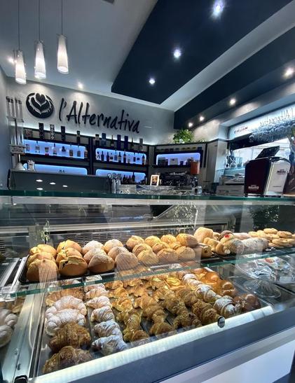 A bakery display case full of pastries and breads.