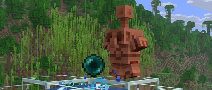 Copper Golem Statue in a star pose standing next to bubble column containing an Ender Pearl, a hill covered by Jungle is in the background