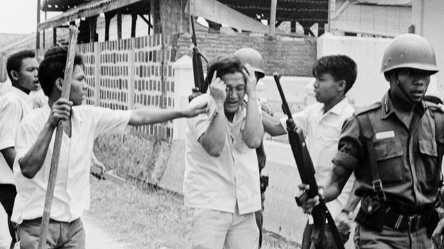 Student being arrested during the Indonesian genocide.