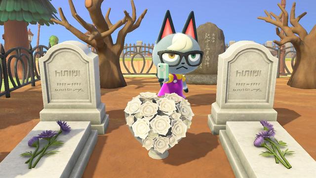 Animal Crossing: New Horizons screenshot. Image shows a dirt ground area with a row of two graves. The two graves shown have a flowers between them. Behind the graves is Raymond with his cell phone out taking a selfie, it seems. Behind Raymond is a stone between two brown, twisted, empty trees