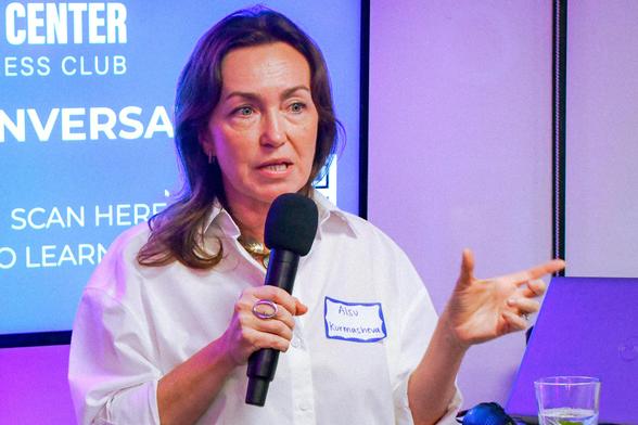 Alsu Kurmasheva speaking into a hand-held microphone.