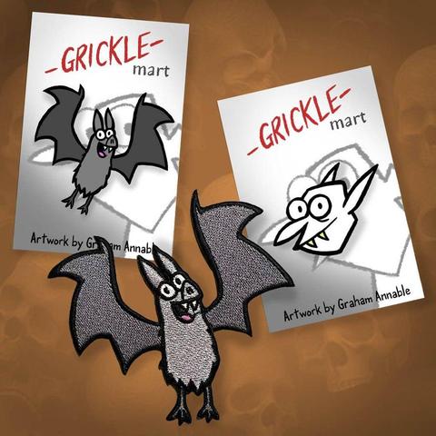 An image of a Grickle Bat pin, a Grickle Vampire pin and a Grickle Bat patch. Available at gricklemart.com
