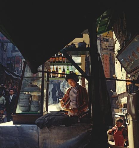 woman cooking under bottlelight