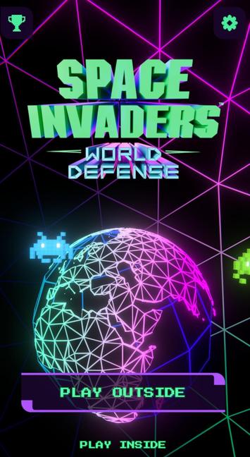 The colorful retro arcade style intro screen of the now mostly defunct Space Invaders: World Defense mobile AR game