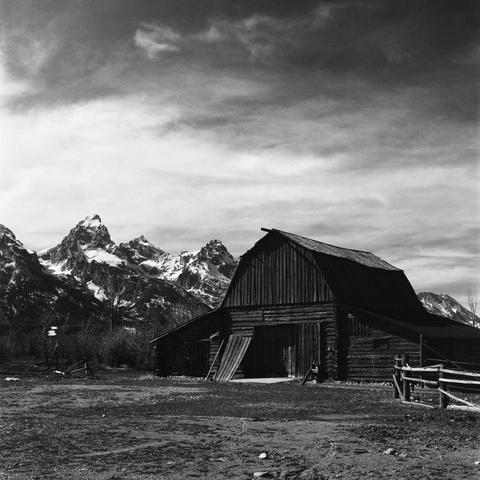 The 4 Lazy F barn, with Grand Teton, Mount Owen, and Teewinot Mountain in the background.