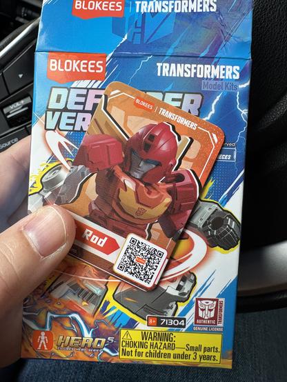 An open Blokees box (the tiny chibi ones) with the Hot Rod card from inside held in front of it.