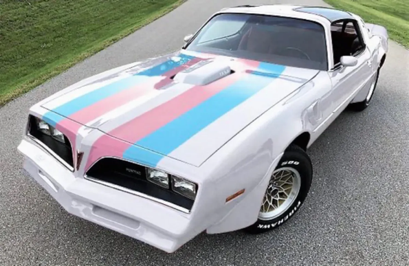 photo of a Trans Am (the car, you know, a sportscar) painted with trans colours (white, light blue and pink)