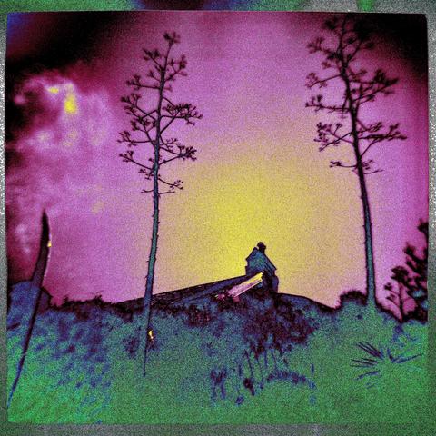 very grainy film photo of a small building far away on a ridge, with two trees framing it on either side. the image has been colorized to show a deep purple sky, with a yellow circle behind the tiny structure. the effect is a kind of psychedelic vintage landscape photo
