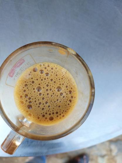 A mug filled with frothy coffee.