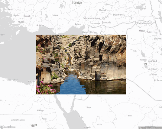 A photo of or from a national park from the linked website, overlaid on a cropped world map where it's located.