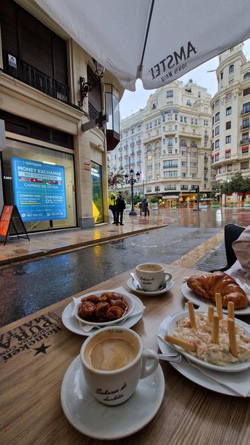coffee croissant, pigtail and salad. in the background the art nouveau buildings