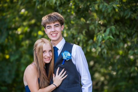 Picture of a boy and girl all dressed up and going to the homecoming dance.