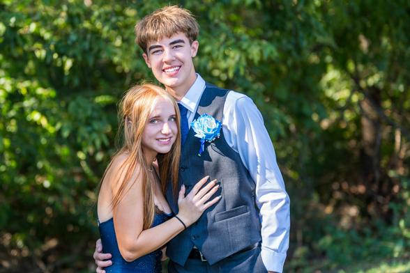 Picture of a boy and girl all dressed up and going to the homecoming dance.
