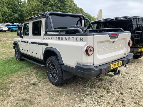 Beige Ineos Quartermaster four-door pick-up, rear quarter view