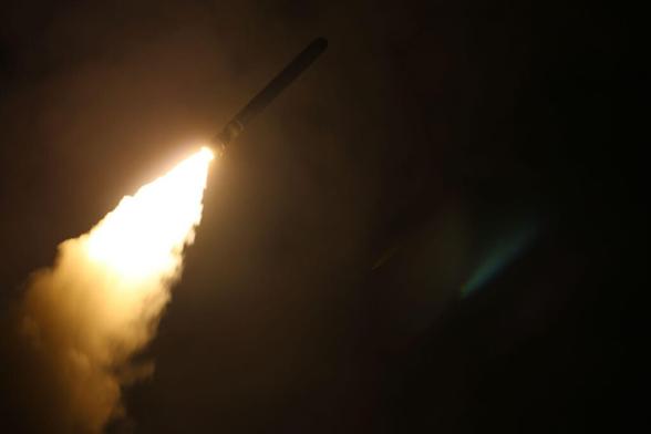 The guided-missile destroyer USS Laboon (DDG 58) fires a Tomahawk land attack missile at a target in Syria from the U.S. 5th Fleet
