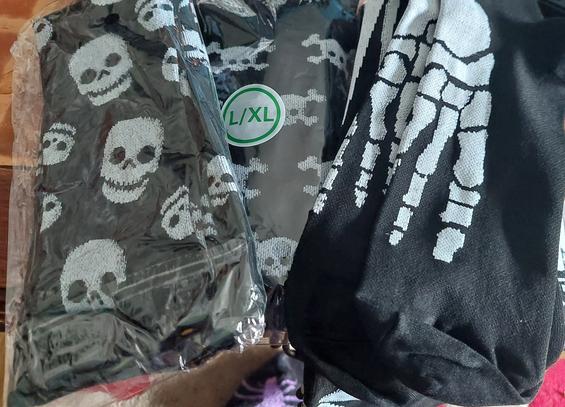 Compression socks black with skulls, skulls & crossbones and foot bones on them.
