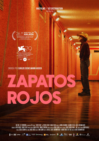 "Zapatos rojas" di Carlos Eichelmann Kaiser, 82 minuti, 2022.
-In una località remota tra le montagne del Messico vive Artemio, un contadino che si vede sfuggire dalle mani il desolato appezzamento di terra su cui lavora e la sua stessa vita. Quando riceve una notizia sconvolgente, decide di partire per la città…- da themoviedb.org 

Locandina del film Zapatos Rojos (2022), diretto da Carlos Eichelmann Kaiser. Al centro, un uomo con cappello da cowboy è ritratto in un corridoio dai muri rossi, illuminato in modo drammatico. Il titolo “ZAPATOS ROJOS” appare in grandi lettere rosa nella parte inferiore, mentre in alto sono visibili i loghi del Festival di Málaga e della Mostra del Cinema di Venezia. La scena trasmette un’atmosfera cupa e riflessiva, coerente con la trama del film, che segue Artemio, un contadino messicano in viaggio verso la città dopo una perdita sconvolgente.