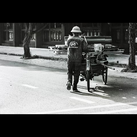 B&w street photography of a vietnamese man in the Ninh Binh city, Vietnam