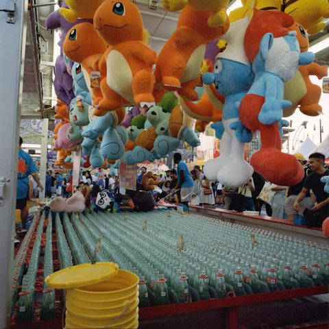 Toss a ring on a bottle a win one of the colourful stuffies hanging all around the game booth.