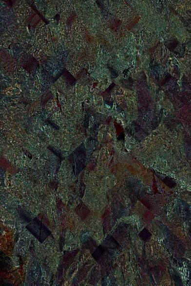 A photo of patterns in the sand has been digitally modified into a dark grainy green surface with small dark charcoal and rust-coloured distorted rectangles, that suggests the surface is in the process of crystallizing.
