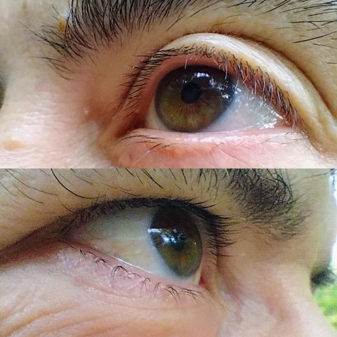 @oehlda2000 Close-up shot of an eye, filling most of the frame. The eye has a hazel iris with darker flecks and a prominent dark pupil. Above the eye are dark, thick eyebrows and visible eyelashes. The skin around the eye shows fine lines and texture, and a subtle reflection of light can be seen in the iris. The background is slightly blurred, suggesting a shallow depth of field.