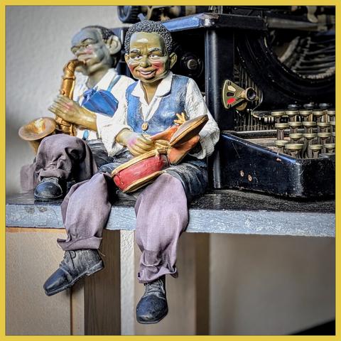 Two small nice colorful statues of players from a jazz orchestra.