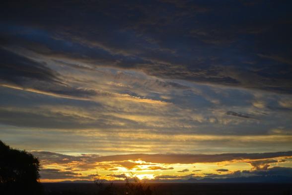 A photo of a sunset through norwester clouds over the Southern Alps as seen from the Cashmere hills of Christchurch city. In this photo the sun has just dipped below the mountains.

My full-res photo is on Flickr at https://www.flickr.com/photos/mollivan_jon/54844913189/