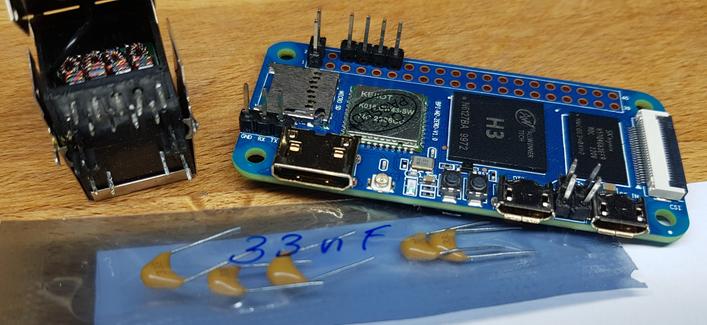 RJ45 connector with integrated "magnetics" (transformers), beside a Banana Pi M2 Zero, and a baggy of 33nF ceramic caps