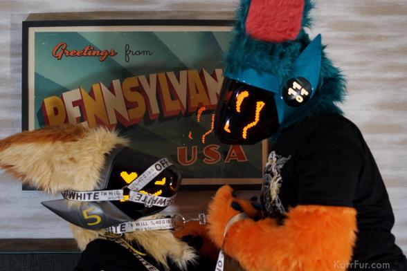 Korr (left) trying to take on Nibble (right). There is a photo behind them that says “Greetings from Pennsylvania U.S.A.”. This was taken during WPAFW 2025.