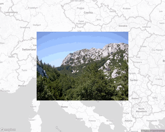 A photo of or from a national park from the linked website, overlaid on a cropped world map where it's located.