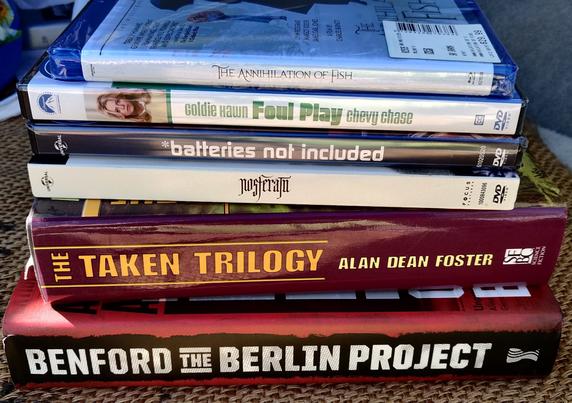 Four sale movies from Barnes and Noble, and two garage sale sff hardcovers, stacked up spines showing. This is from today.