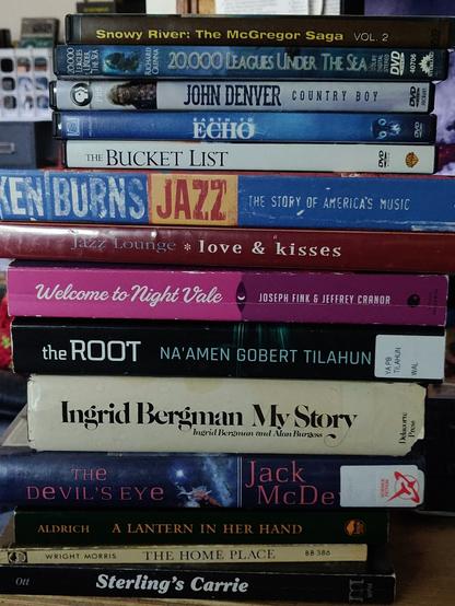 Four books, two jazz collections on CD,four movie DVDs and what looks like an incomplete and home burned Australian TV series. Not clearly marked, that. In a stack, spines showing. This is from yesterday.