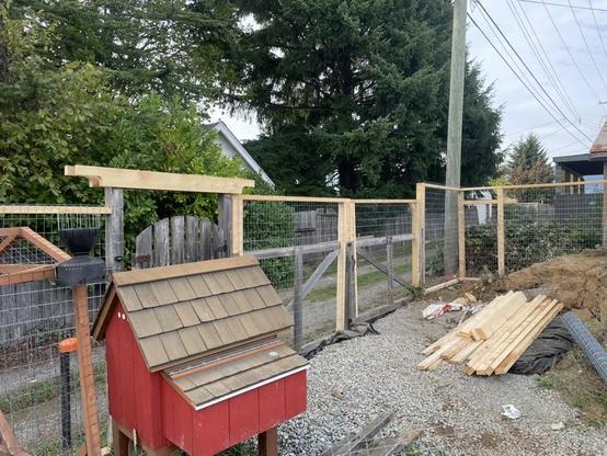 Fresh wood is added to the top of the fencing to make it taller.