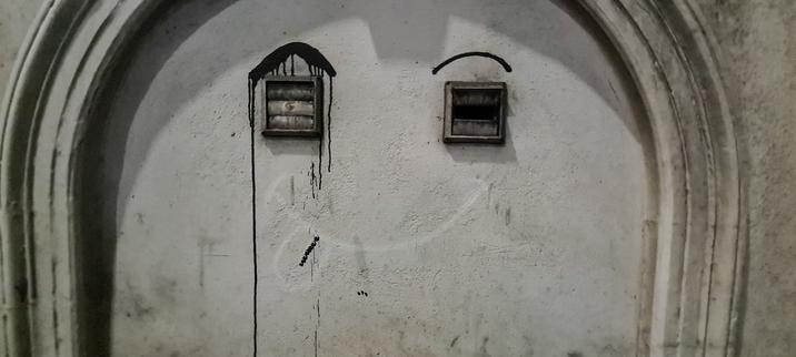 Under two small air vents someone has drawn a mouth with its tongue sticking out, and above the vents are two eyebrows, creating the appearance of a face.