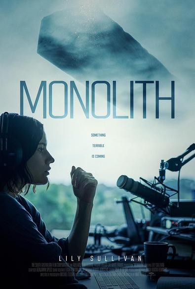 The poster of the film, featuring a young woman sitting at a table in front of a microphone and a large window. In the background, a misty brick-like object floats in the sky. The caption”Something terrible is coming” appears in the middle of the poster. The actress’s name (Lily Sullivan) appears at the bottom of the screen.