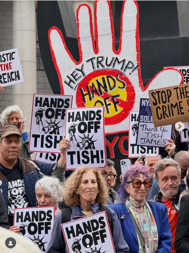 A group of New Yorkers holding signs with the Statue of Liberty on them that read "HANDS OFF TISH!" Protest in support of NY AG Letitia James, who successfully prosecuted Trump and is now facing bogus charges of mortgage fraud as a consequence.
