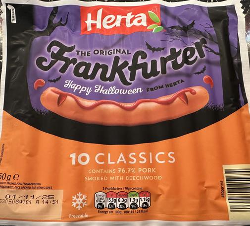 A packet of hot dogs in orange and purple Halloween themed packaging
