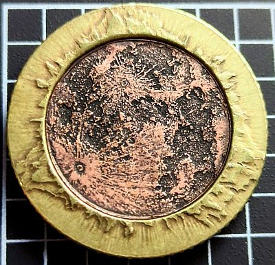 2024 Solar Eclipse Medallion

a face of Earth's only moon which is a geographically (technically selenographically) correct 136,794,240:1 scale design of the surface texture of its near side in copper, with the surrounding solar corona struck in brass.