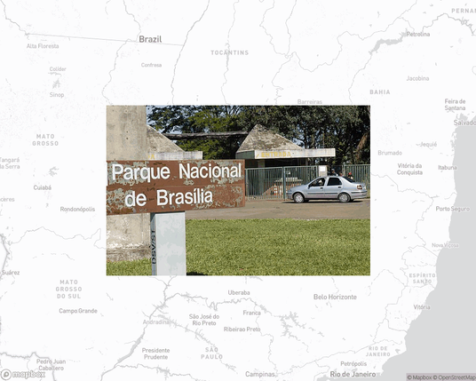 A photo of or from a national park from the linked website, overlaid on a cropped world map where it's located.