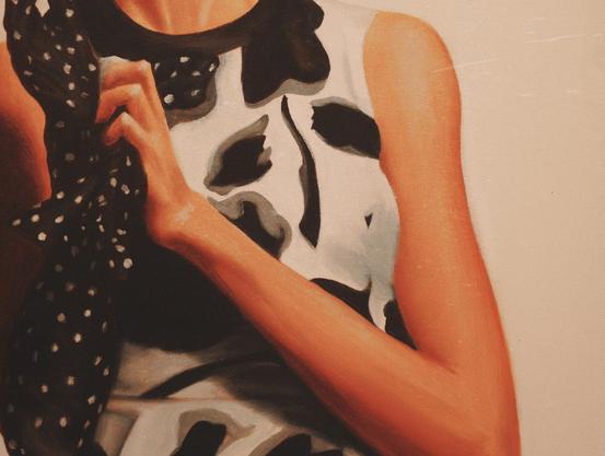 Unfinished painting shows a woman’s hand holding a black polka-dot glove with warm orange tones on the arm.