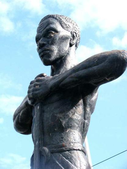 Statue of Paul Bogle in Morant Bay, Jamaica. By dubdem sound system – Flickr: Dubdem Sound System :: Jamaican Tour 2009, CC BY 2.0, https://commons.wikimedia.org/w/index.php?curid=28291876