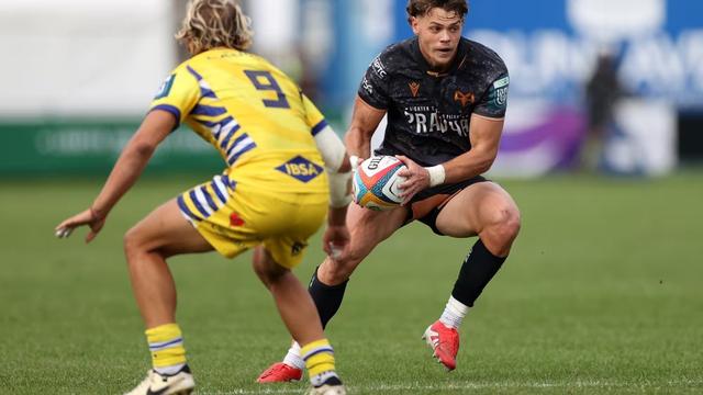 Ospreys full‑back Jack Walsh carries the ball under pressure from Zebre No.9 Thomas Dominguez in the URC match at the Brewery Field, where the Welsh side sealed a 24–0 victory.