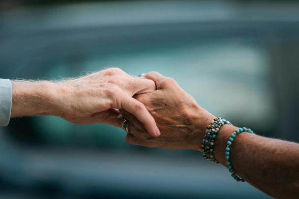 close up of elderly hands holding in comfort