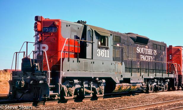 Half repainted Southern Pacific (SP) "half-widow" 3611 at Roseville, CA, with GP9 3694 on Tuesday, Aug. 6, 1974.
