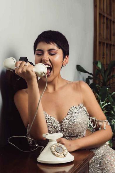 glamorous woman posing with vintage telephone