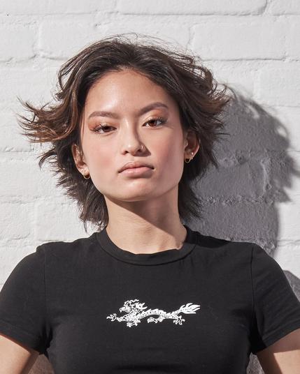 Headshot of a woman leaning against a wall.