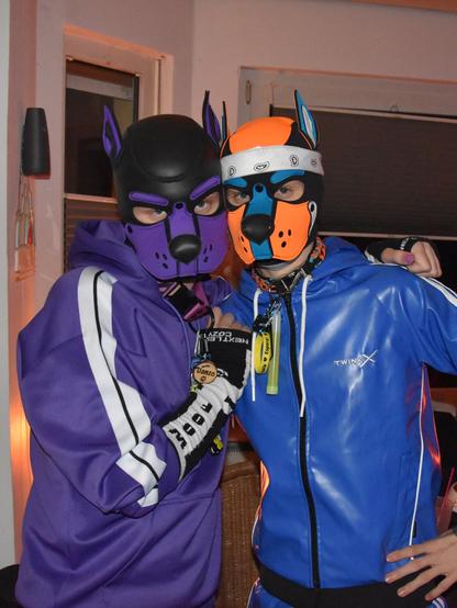 Danzo and Aki in matching outfits with white stripes on the sides. Danzo in his usual purple and Aki in blue.