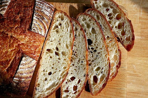 Slices of the loaf baked yesterday fanned out to show a fairly open crumb typical of a sourdough.