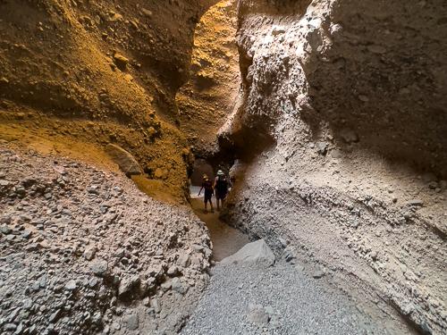 photo of hikers in a narrow slot canyon in Death Valley National Park