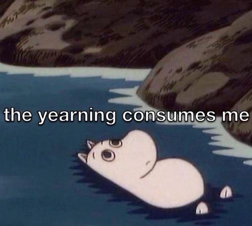 moomin laying in shallow water by a rocky shore with the words “the yearning consumes me” overlayed